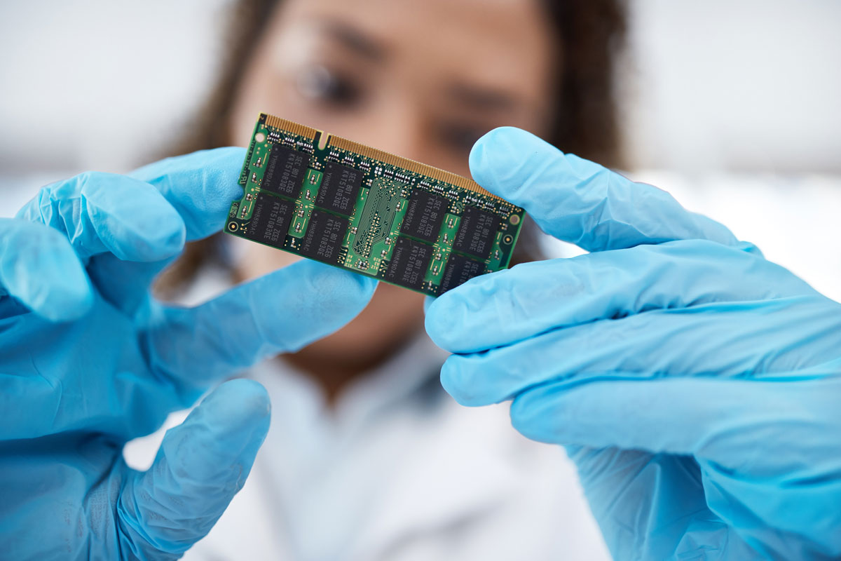 A technician inspecting a PCB for quality control.